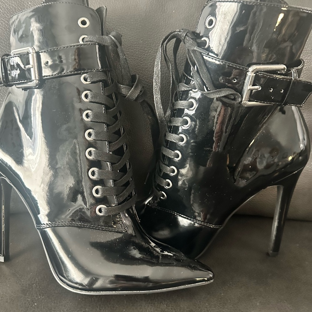 Lace up boot with side zipper closure. Paten leather. Never worn.